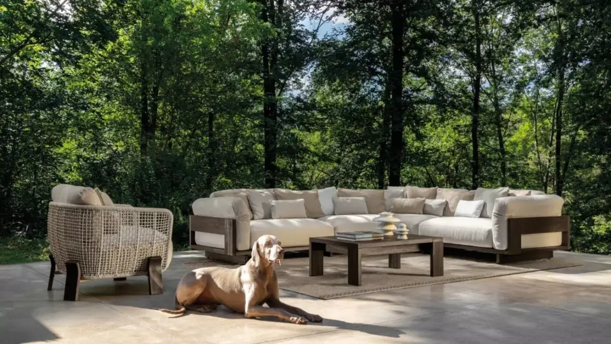 Arredamento da Esterno in Legno - Divano modulare in legno con cuscini beige morbidi ambientato in un giardino con gli alberi
